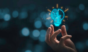 Hand reaching toward a glowing lightbulb with brain and circuit patterns, symbolizing innovation and digital technology
